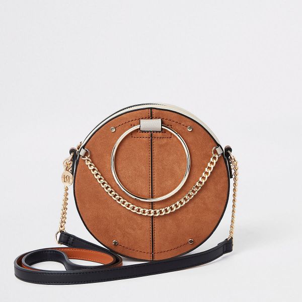 Beige ring handle circle cross body bag